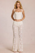 Pantalones acampanados de tiro medio con encaje transparente en color perla