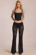 Pantalones de encaje transparente de tiro medio con campana en negro